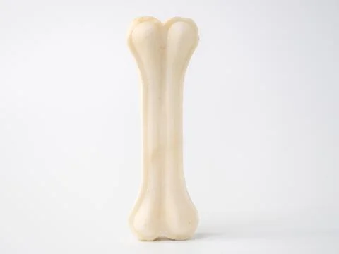 Pressed rawhide bone shaped dog chews. Stock Photos