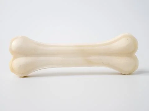 Pressed rawhide bone shaped dog chews. Stock Photos