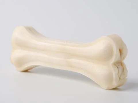 Pressed rawhide bone shaped dog chews. Stock Photos
