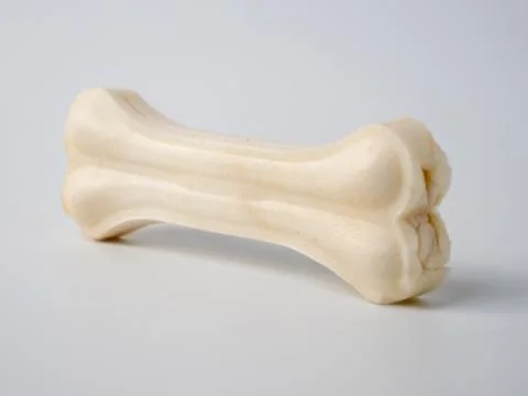 Pressed rawhide bone shaped dog chews. Stock Photos