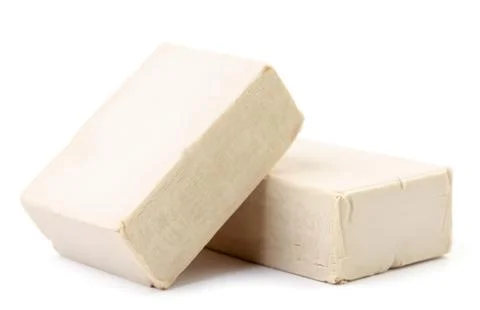 Pressed yeast on a white background. Isolated Stock Photos