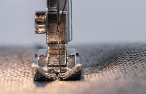 Presser foot with needle and thread with selected focus and copy space. Sewin Stock Photos