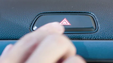 Presses the emergency stop button in the car Stock Footage 98962589
