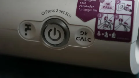 Pressing the on and off button of the steam iron Video stock 141511714