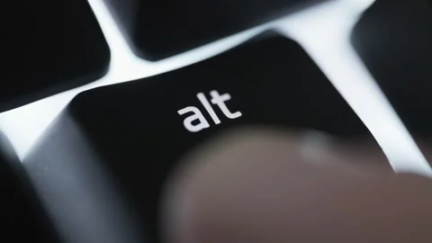 Pressing and holding the ALT button on black computer keyboard Stock Footage 264160659