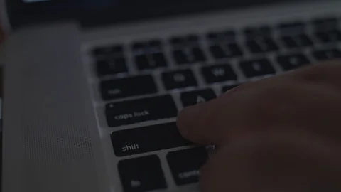 Pressing and using shift, caps lock, tab, and escape on a laptop keyboard. Stock Footage 88684928