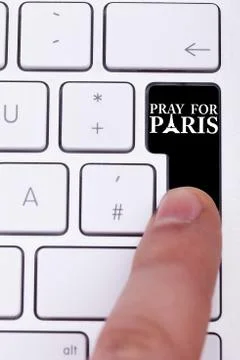 Pressing black button with pray for paris text and sign Stock Photos