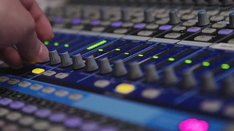 Pressing a button and adjusting a knob on an audio mixing board 库存影片 89496040