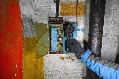 Pressing a button by hand on the control panel in an old abandoned bunker wit Stock Photos