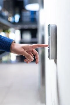 Pressing button on security keypad, person entering office building Foto stock