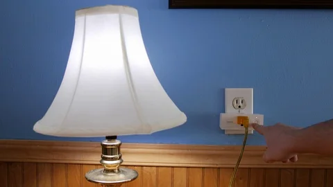 Pressing Button on Smart Plug to Turn Lamp On and Off Vídeo Stock 104005025
