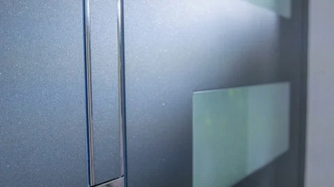 Pressing a button so that the front door opens and a man walks through Video stock 83910361