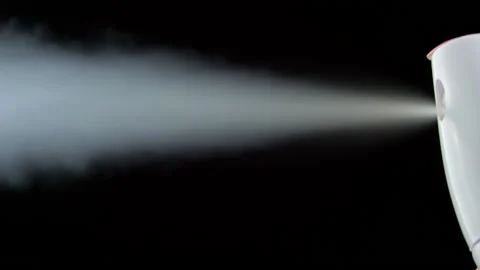 Pressing a Button on White Deodorant Spray with Jet Stream on a Black Background Stock Footage 187990890