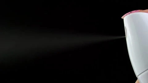 Pressing a Button on White Deodorant Spray with Jet Stream on a Black Background Stock Footage 188144472