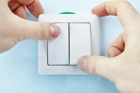 Pressing buttons of light switch. Fotos de archivo