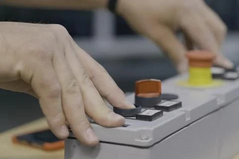 Pressing buttons on the machine control panel. Production &amp; Control Panels Stock Photos