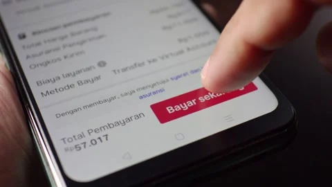 Pressing Buy button on smartphone screen orange Order Confirmed Stock Footage 293999144