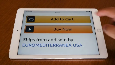 Pressing "Buy now" button at online shopping portal, with Apple Ipad Video stock 114327997