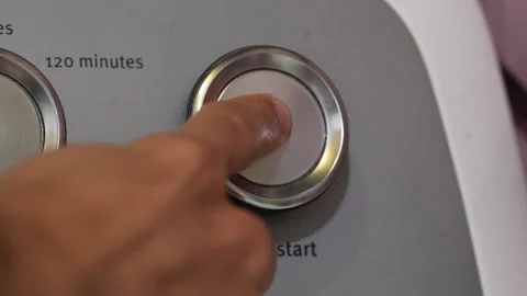 Pressing the clothes dryer's push-to-start button. Stock Footage 264639310