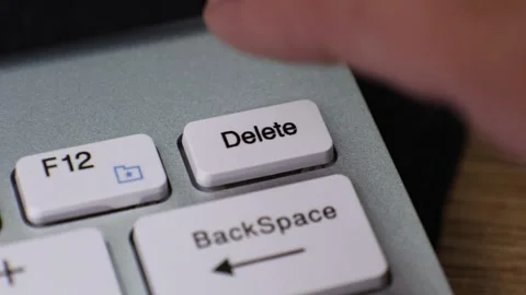 Pressing delete key on computer keyboard close-up Video stock 336965814
