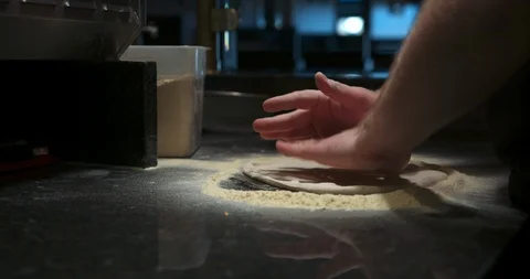 Pressing down and tossing dough by hand Stock Footage 104967034
