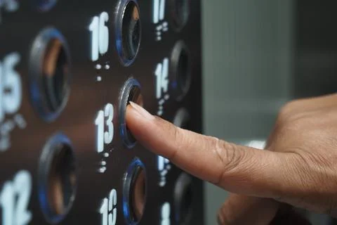 Pressing the elevator button for the 13th floor Foto stock