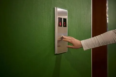 Pressing the elevator button in contemporary high rise buildings signifies Foto stock