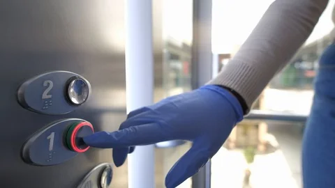 Pressing the Elevator Button in Rubber Gloves Video stock 128419260