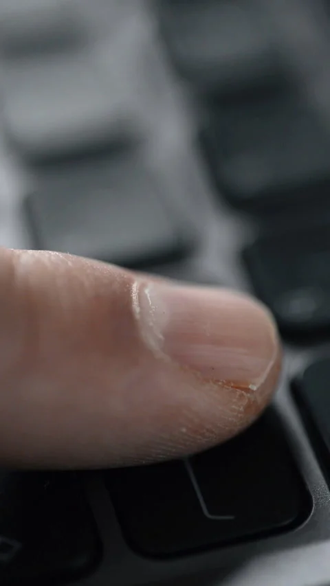 Pressing the Enter key on a keyboard. Close-up. Vertical video. Stock Footage 325704919