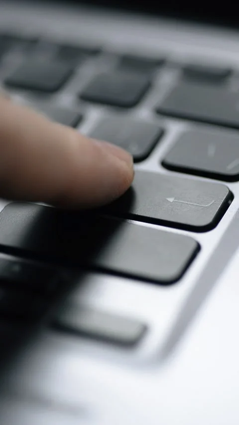 Pressing the Enter key on a keyboard. Close-up. Vertical video. Stock Footage 325704962