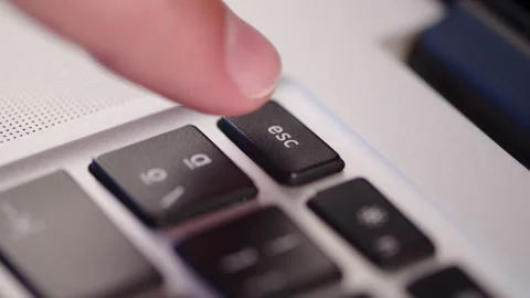 Pressing an escape ESC key on a laptop close up. Canceling a command on a c.. Stock Footage 340958658