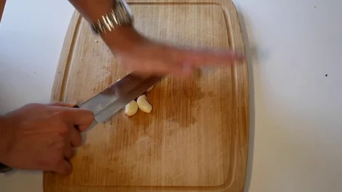 Pressing Garlic with a kitchen knife Stock Footage 79284886
