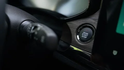 Pressing the ignition switch button to start the electric motor of a hybrid car Video stock 253573529