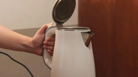 Pressing the lid release button of an electric kettle after boiling water Stock-Footage 343334123