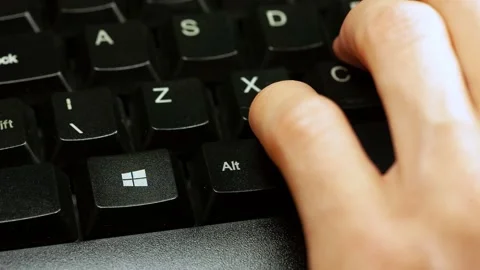 Pressing the Microsoft Windows 10 operating system key on a keyboard Stock Footage 143789778