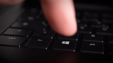 Pressing Microsoft Windows Start button key with red color Stock Footage 121288033