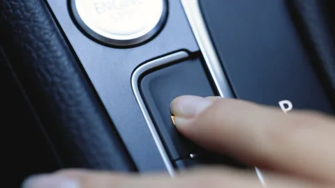 Pressing the MODE button inside an electric car to activate the electric motor Stock Footage 200833982