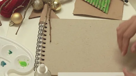 Pressing the painted corrugated side of a triangle cut out on a thick paper  Stock Footage 291160903