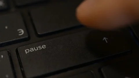 Pressing the pause button on on laptop or computer keyboard Stock Footage