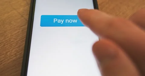 Pressing the Pay Now button on the smartphone screen. Order confirmed, response 動画素材 263477867