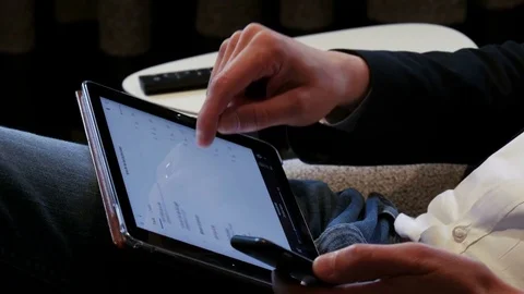 Pressing the play button and listening to music on tablet computer 4 K Stock Footage 76085584