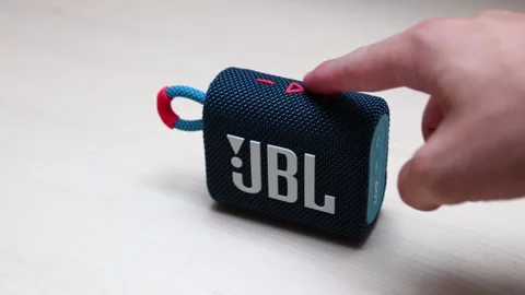 Pressing play button on JBL GO3 Speaker Stock Footage 282185300