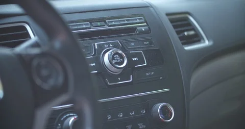 Pressing the power button to turn on the CD player on a car radio Stock Footage 113359924