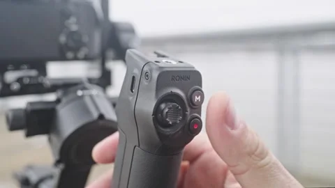 Pressing Record Button on DJI RS 5 Briefcase Handle tight shot Stock Footage 332686682