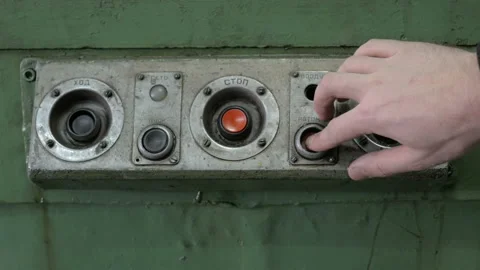 Pressing the red push buttons on a control panel Stock Footage 87725721