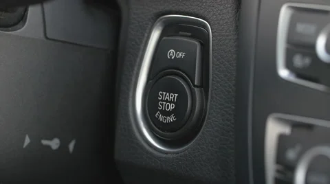 Pressing the start and stop button on a car Stock Footage 64335786