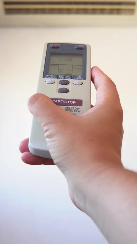 Pressing  start button on air conditioner remote control Stock Footage 276578377