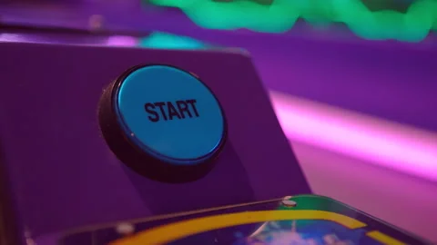 Pressing START button on arcade ball game 4k Stock Footage 142340536