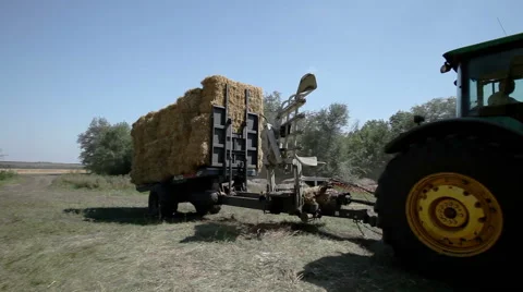 Pressing straw into ricks by baler 스톡 동영상 62780621