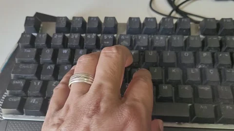 Pressing various keys on a computer gamer-type input device Stock Footage 274035584
